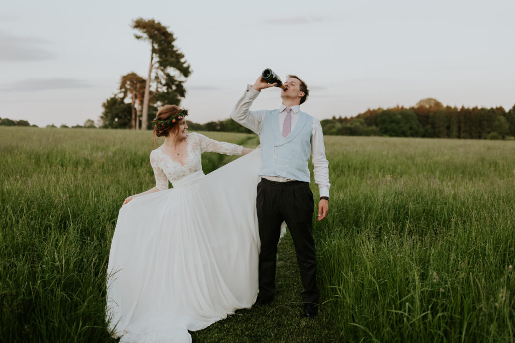 bride and groom dancing in a field